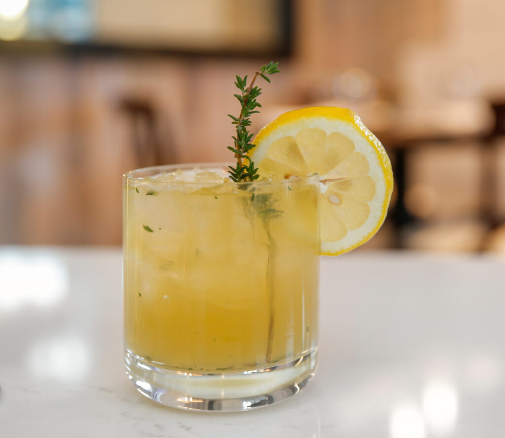 a cool, refreshing cocktail garnished with a lemon slice