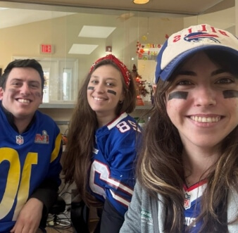 Smiling staff wearing football jersies