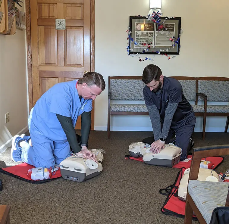 The doctors performing CPR on some test dummies