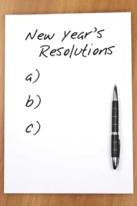 a piece of paper on which is written "new year's resolutions"