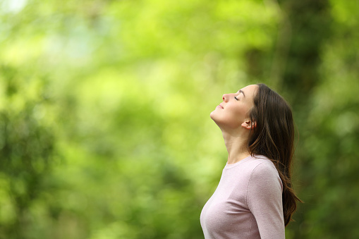 a woman outside soaking in nature