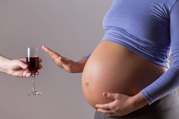 a pregnant women declining alcohol, backing up one of the pregnancy myths: pregnant women shouldn't drink any alcohol.
