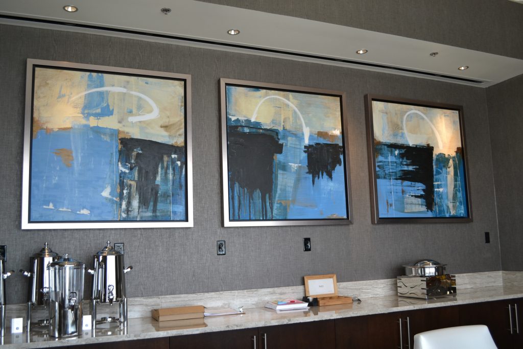 pieces of art on the wall of an office building