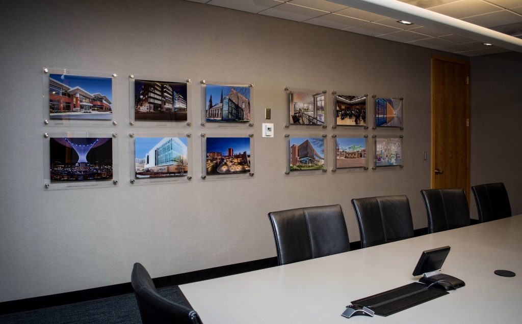 framed photos on the wall of a conference room