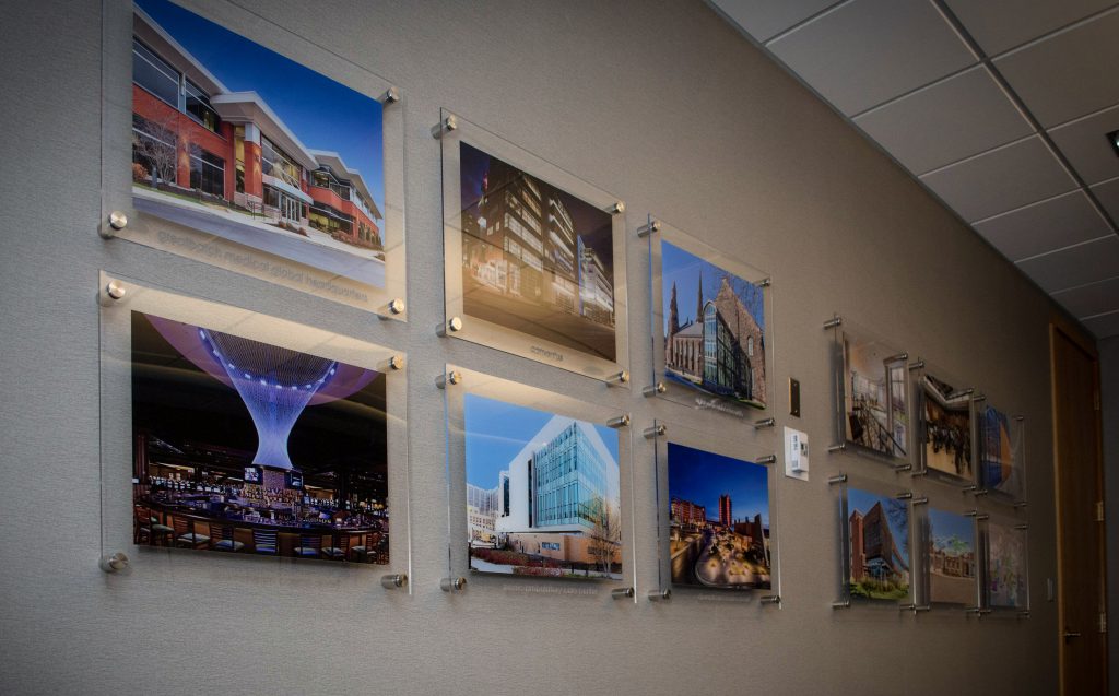 framed photos of cityscapes on the wall of a conference room