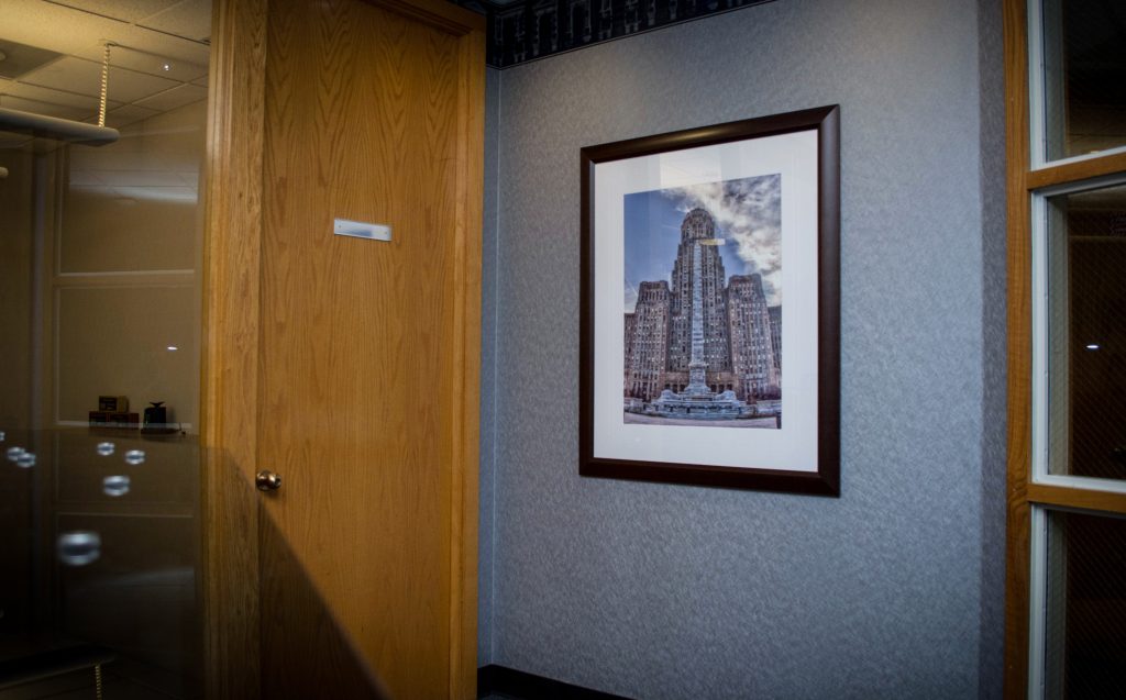 a framed photograph of a high rise building