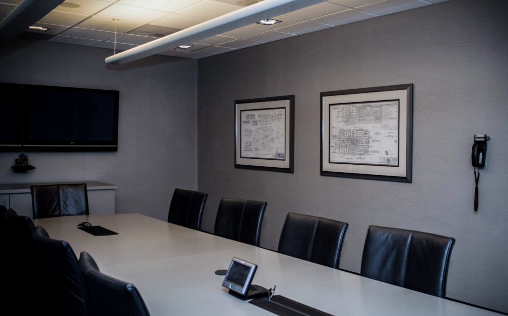 framed blueprints on the wall of a conference room